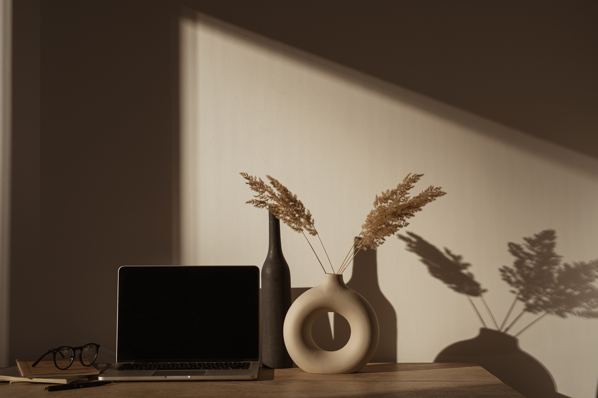 Laptop Computer  with Pampas Grass in Vase on Desk